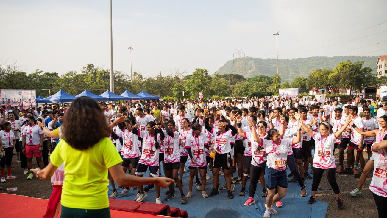 Hundreds of runners warm up together before the start of She Run 2025.
